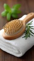 A wooden brush and towel with rosemary sprig photo
