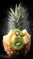 Fresh pineapple with kiwi fruit being sprayed with water photo