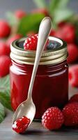 Raspberry jam with spoon photo