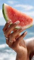 A woman holding a slice of watermelon photo