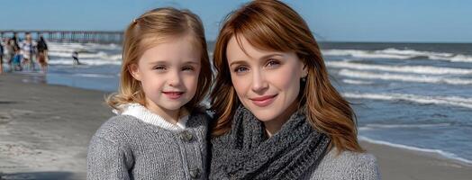 Two young girls are posing for a photo on the beach