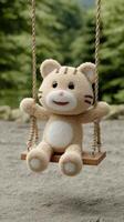 A stuffed animal on a swing photo