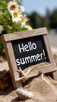Hello summer sign in the sand photo