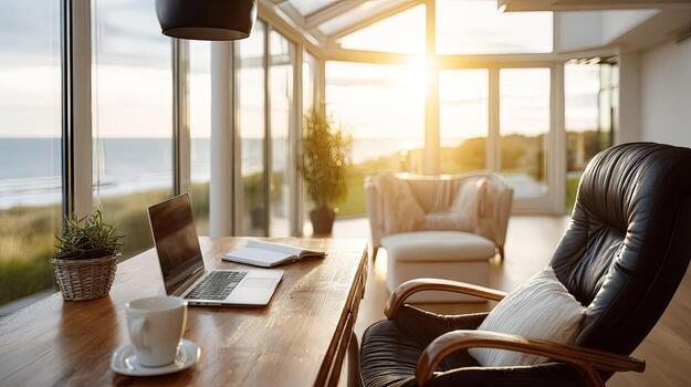 A laptop sits on a table in front of a window photo