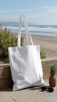 A white tote bag sitting on a bench near the beach photo