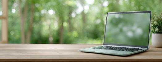 Laptop on wooden table with blurred background photo