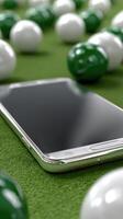 A white phone laying on a green field with a bunch of white balls photo