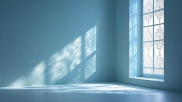 Beautiful light patterns cast by an intricate window design in a serene blue room during daytime photo
