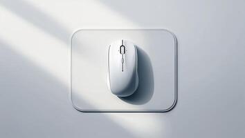 Minimalist white computer mouse on a grey surface illuminated by soft natural light in an indoor setting photo