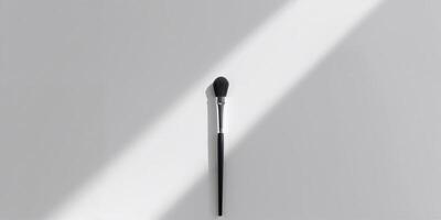 Makeup brush in soft sunlight on a light background, showcasing the simplicity and elegance of beauty tools photo
