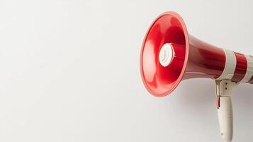Red megaphone resting against a white wall ready for use in a public announcement or event photo