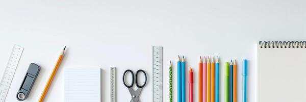 Colorful assortment of stationery items arranged neatly on a white surface for school or office use photo