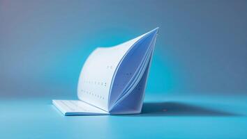 Unique design of an open notepad with perforated pages standing on a blue surface under soft lighting photo