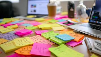 Colorful notes scattered on a workspace during brainstorming session in a creative office setting photo