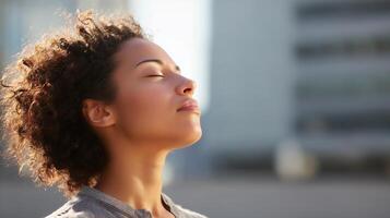 Woman enjoying tranquility outdoors in a city setting with a serene expression during daytime photo