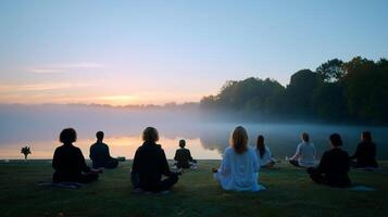 Morning meditation session by the lakeside with participants engaged in mindfulness practice photo