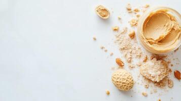 Creamy peanut butter spread with crushed nuts and ingredients on a white background photo