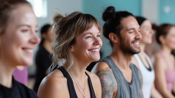 Group of individuals smiling during a yoga class in a bright, spacious studio during morning hours with natural light photo