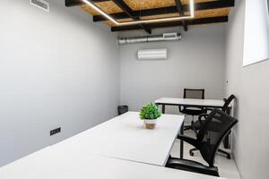 Modern workspace featuring minimalist design and functional furniture in an office setting photo
