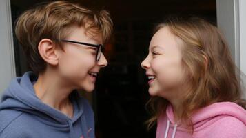 Siblings enjoying playful moment indoors while sharing laughter and joy together in the evening hours photo