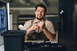 Skilled worker operating power tools in workshop setting during afternoon hours photo