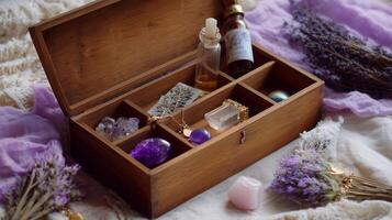 Wooden box filled with crystals, essential oils, and dried lavender on a soft fabric backdrop photo