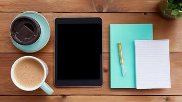Workspace setup with coffee, tablet, and notepad for productivity and creativity photo