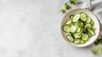 Fresh cucumber salad preparation with herbs and spices on a clean surface photo