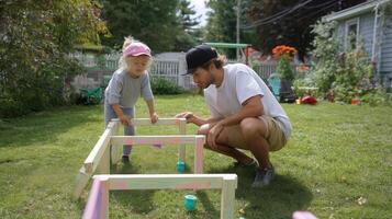 Child and adult engage in creative building projects in a backyard garden on a sunny day photo