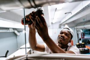 Electrician works with power tools in modern commercial building near city center after hours photo