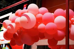 Colorful balloon display enhances the vibrant atmosphere at a festive event in an urban setting photo