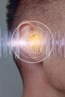 Conceptual representation of sound waves interacting with human hearing in a digital art setting photo