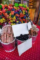 Colorful spices and herbs displayed at a bustling market in Morocco during the afternoon photo
