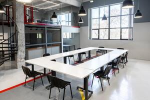 Modern coworking space designed for collaboration in an urban setting with ample natural light during daylight hours photo