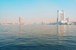 Majestic view of Cairo skyline over the Nile River on a clear morning showcasing urban architecture and tranquil waters photo