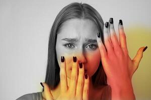 Expression of emotion with contrasting hands and face in muted colors photo