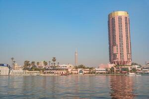Skyline view of Cairo featuring the Nile River and modern architecture at sunset photo