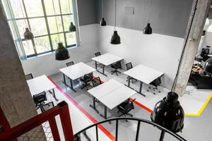 Modern coworking space with large windows and minimalist design in a busy urban setting photo