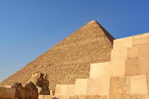 Remarkable view of an ancient pyramid against a clear blue sky in Egypt during midday photo