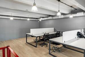 Modern co-working space with minimalist design and ample natural light in a bustling urban setting photo