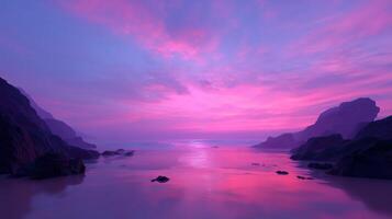 Vibrant sunset over tranquil ocean with purple and pink hues reflecting on calm waters at a coastal location photo
