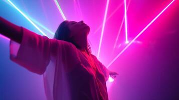 Bright colored lights create a vibrant atmosphere as a person enjoys the party at a nightlife venue photo