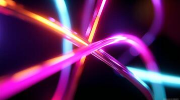 Colorful neon light trails intersecting in a dark space at night creating a vibrant and dynamic visual effect photo