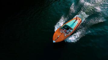 Speeding across calm waters in a vintage boat under clear skies during a sunny afternoon photo