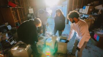 Group of friends sorting through old electronics in a cluttered storage space during the afternoon light photo