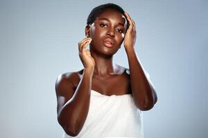 Model posing with elegant gestures in a studio setting, showcasing beauty and skin care elements, emphasizing natural radiance and confidence photo