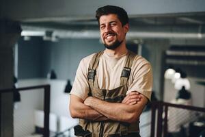 Smiling man in work attire stands confidently in a modern workspace during daylight hours photo