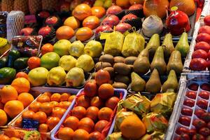 Colorful variety of fresh fruits displayed at a market in the evening light photo