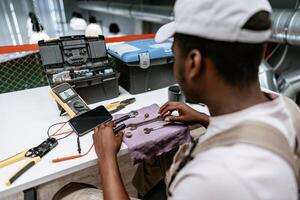 Professional technician working on tools at a workshop during the afternoon photo