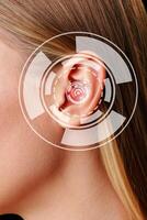 Close-up view of a woman's ear with digital sound wave representation in a modern setting during daylight hours photo